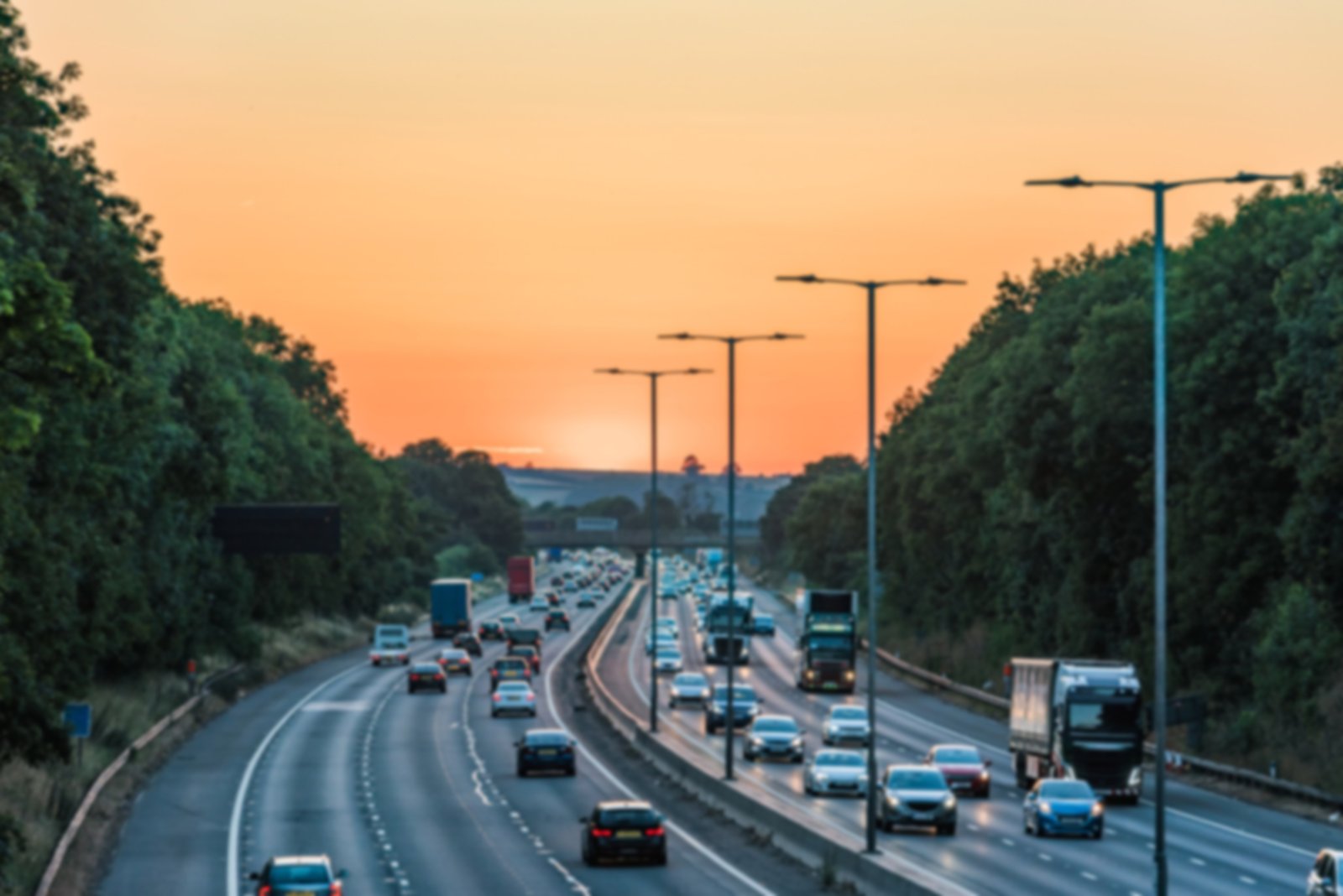 Busy motorway traffic at sunset
