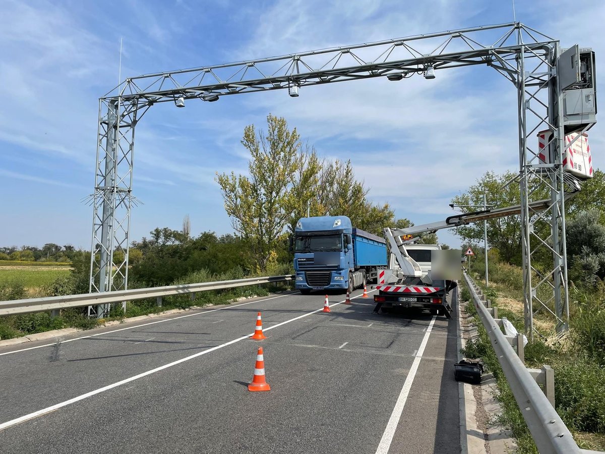 Engineers commissioning a WIM and ANPR gantry over a highway